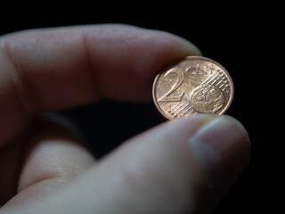 Holding a Two-Cent Euro Coin with Fingers