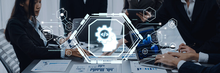 A dynamic business meeting scene showcasing a team collaborating on technology solutions, utilizing laptops and digital graphics to enhance discussions and analyses. Trope