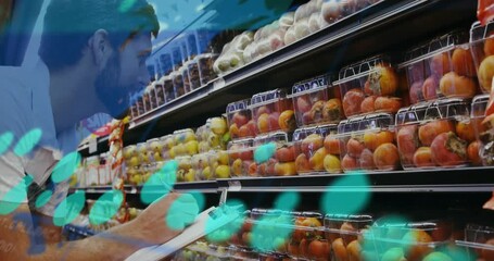 Worker auditing produce in aisle, inspecting clamshells while teal readouts overlay, logging stock