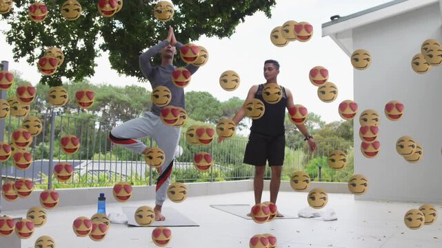 Two men doing yoga patio moving into tree pose, mats bottles for balance, midway emojis overlaying