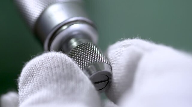 Industrial Drill Bit in Worker's Glove - Manufacturing Tool Close-Up