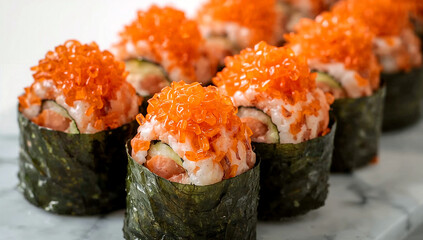 Seaweed wrapped sushi rolls with cucumber and salmon roe