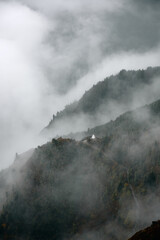 Fog blankets mountains at dawn in remote nature location, creating a mysterious scene