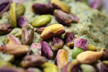 Close up view of a bowl of pistachio paste featuring a generous amount of shelled nuts providing a high protein and healthy fat snack option