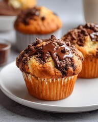 Delicious chocolate chip muffins on a plate.