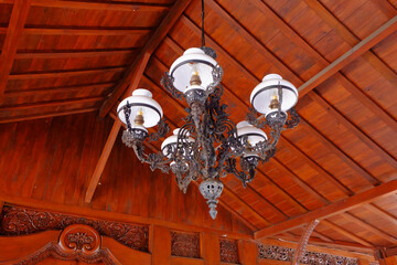 an old classic lamp installed on the ceiling adds to the aesthetics of the room