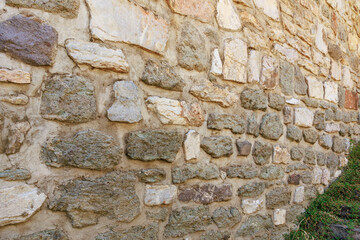 Rustic stone wall with diverse textures and natural patterns outdoors