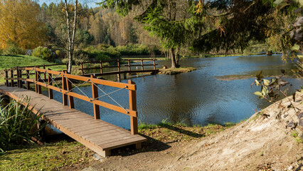 Wooden bridge over pond in autumn park