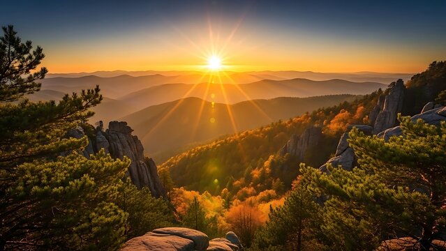 Golden mountain sunset over a vibrant autumn forest landscape with rocky formations.