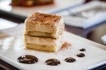 Tiramisu served elegantly on a white plate at a high end Italian food restaurant