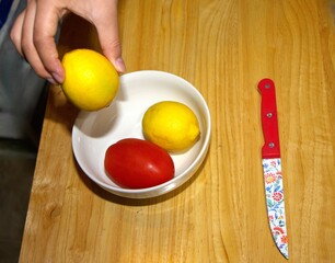 hand holding a bowl of fresh fruit