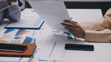 businesswoman using a calculator to calculate the numbers for financial document, finance accounting concept