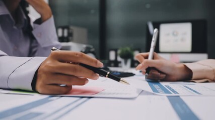 businesswoman using a calculator to calculate the numbers for financial document, finance accounting concept
