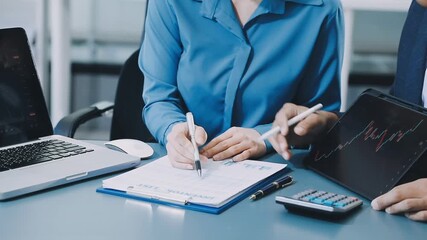 businesswoman using a calculator to calculate the numbers for financial document, finance accounting concept