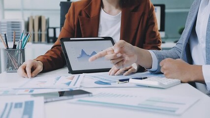 businesswoman using a calculator to calculate the numbers for financial document, finance accounting concept
