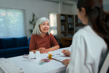 Senior Asian woman receiving doctor consultation and prescription