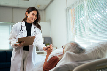 Female doctor comforting senior patient holding hands