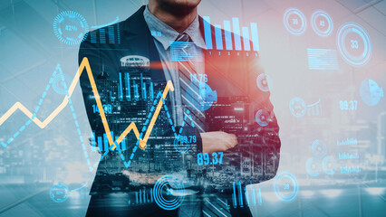 A poised businessman stands confidently with crossed arms, surrounded by dynamic financial graphs and digital data visualizations representing market growth and analysis. Xenic