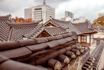 Namsangol Hanok Village, Seoul, South Korea, 04.10.2015: Close-up view of traditional Korean rooftops amidst the backdrop of modern Seoul, showcasing cultural heritage