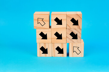 A symbolic representation of contrasting directions using arrow marked blocks arranged to depict decision making, divergence and strategic positioning.
