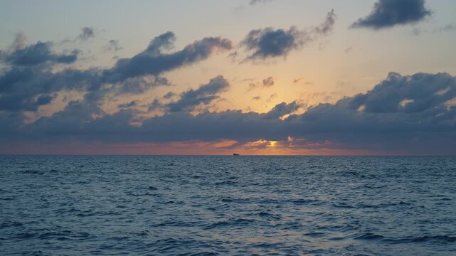 Sea sunset horizon. Sunset cloudy sky. Seascape at summer vacation. Skyscape with sea horizon. Horizon sunrise sea with ship. Sunrise seascape. Romantic summer vacation seascape
