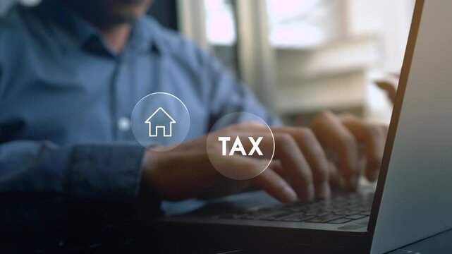 Businessman using a computer to complete Individual income tax return form online for tax payment. Government, state taxes