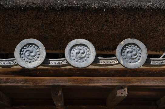 Traditional Japanese Roof Tile Crest (Kawarimon) and Thatch Detail (Close-up)