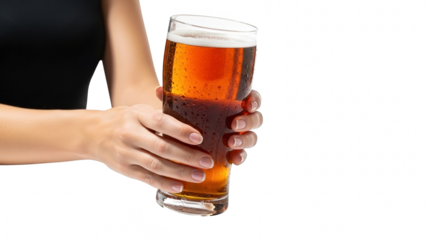 Hand holding a tall glass of amber beer with frothy head
