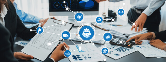 A modern office scene showcasing a business team engaged in collaboration and data analysis, enhanced by digital interface illustrations for workflow optimization. Amity