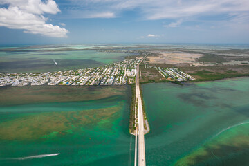 Florida Keys. Key West, Florida. Aerial view of a long highway across tropical blue water, connecting islands with scenic coastal landscape, boats, bridges and summer travel vibes. Tourism vacation US