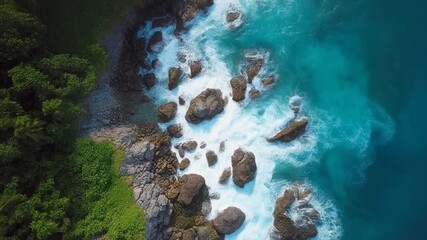 Breathtaking vertical aerial drone footage capturing a stunning tropical coastline from above. Crystal clear turquoise ocean water contrasts beautifully with lush green tropical forest vegetation. Wav - Powered by Adobe