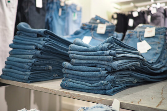 Neatly folded jeans display at a clothing store