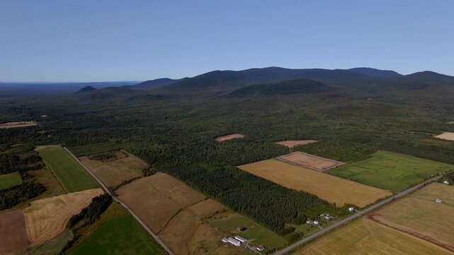Majestic Mountain Backdrop Over Sprawling Farmlands