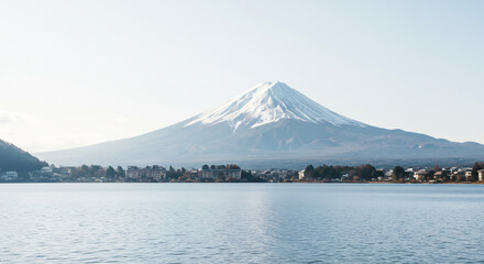 Bright sun illuminates a magnificent snow-capped volcano rising above a peaceful reflective lake and village.. AI Generated