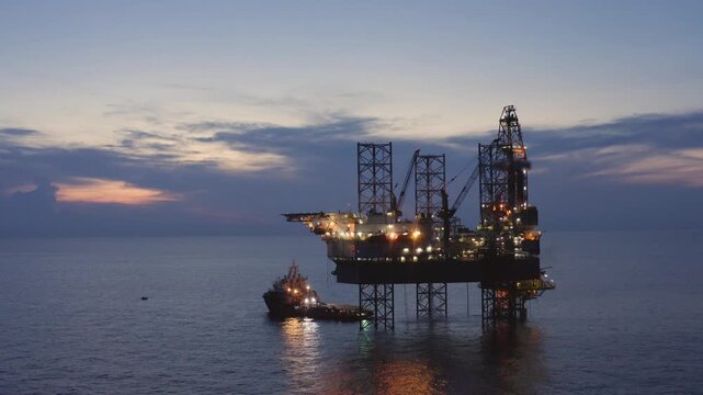 Offshore jack up rig in aerial view in the middle of the ocean taken by a drone
