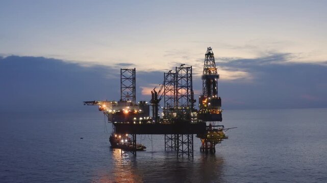 Offshore jack up rig in aerial view in the middle of the ocean taken by a drone
