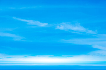 Fototapeta premium A bright, clear blue sky meets a glowing white horizon, suggesting a serene, open, and with sunlight of beautiful cloudy sky. landscape or abstract background. 