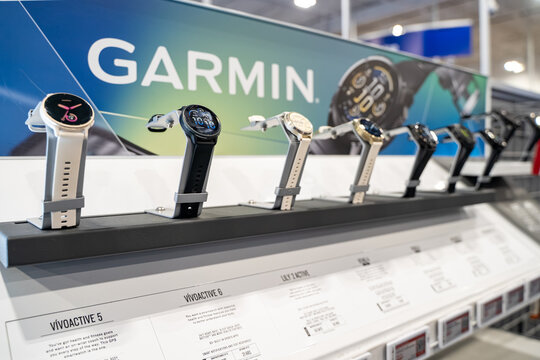 View of Garmin smartwatches displayed on a retail store stand. Milton, Canada - November 29, 2025.