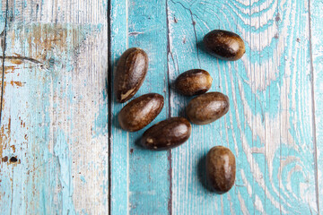 Nutmeg (fragrant nutmeg, true nutmeg, mace, pala) on the table. Used for flavouring many dishes.
