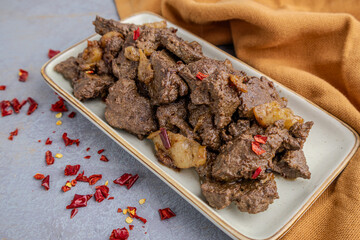 Spicy Pan-Fried Liver with Chili Flakes on a Plate