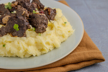 Hearty braised beef liver with creamy mashed potatoes