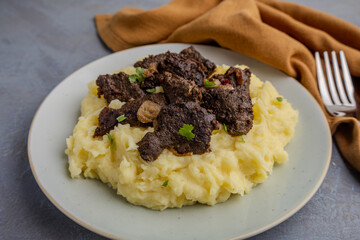 Hearty braised beef liver with creamy mashed potatoes