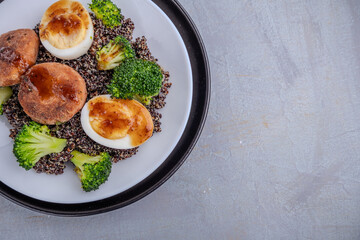 Nutritious Quinoa Bowl with Broccoli, Boiled Eggs, and Savory Patties