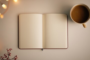 Blank notebook, coffee mug and winter holiday lights, New Year's goals and resolutions, Blank mockup for personal planning, journaling or business notes