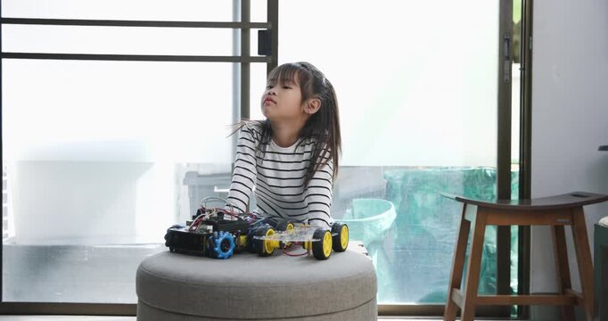 Focused young girl assembling a robot, symbolizing childhood innovation and STEM learning