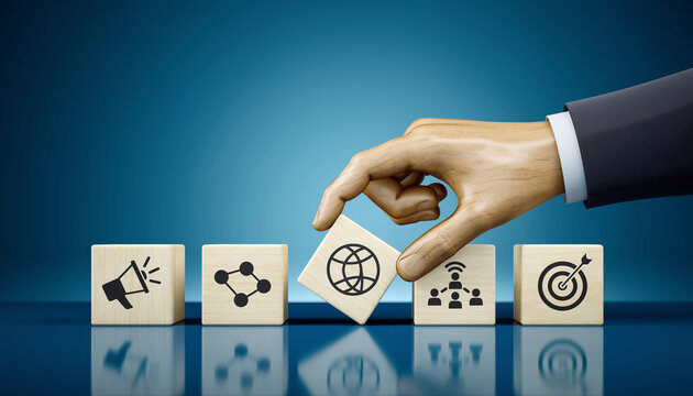 Hand placing a block with a globe icon among other business icons.