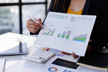 Closeup hand of Chief discuss monthly earning graph Analyzing data dashboard, business analytics, financial chart, together in the office
