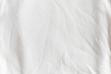 Naklejka premium Close-up of wrinkled white cotton fabric texture. Trendy color of 2026 year