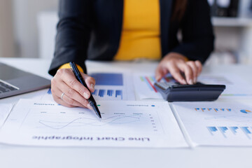 Business woman Auditor or internal revenue service staff checking annual financial statements company Audit  using calculator Accounting tax.

