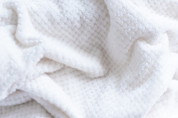Close-up of soft white textured fabric with folds. Trendy color of 2026 year